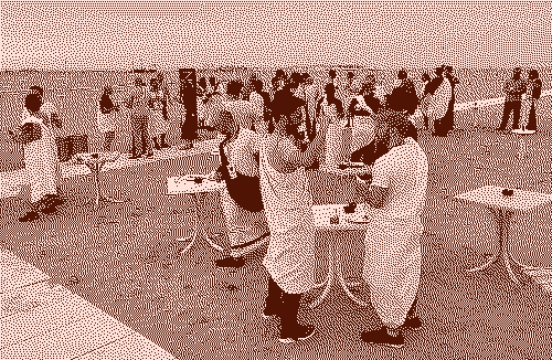 Photo of people in toga having drinks on a beach
